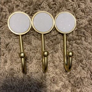 Gold metal wall hooks with white granite inlay